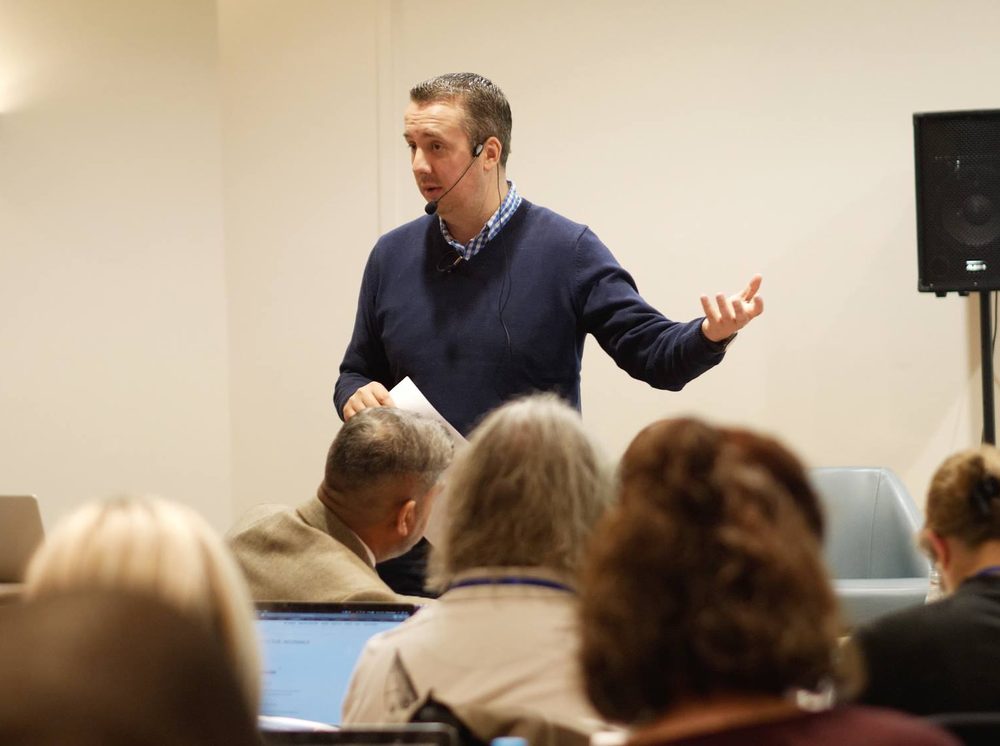 James Nicholson speaking to a room of UK business owners.